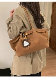 Detailed back view of a large caramel suede tote bag with leopard print heart pendant