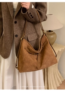 Close-up of caramel retro hobo bag featuring intricate woven texture and leather strap