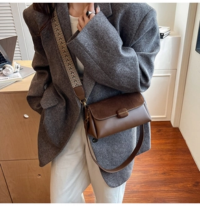 Detail of vintage matte crossbody bag with mixed textures and woven geometric strap