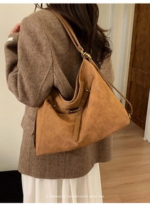 Detail of caramel braided leather texture on a vintage oversized tote bag for women