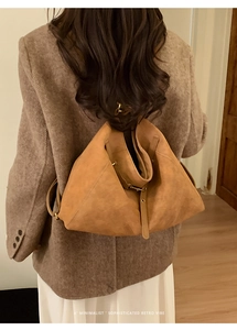 Detailed back view of a large vintage camel suede tote bag with unique triangular structure