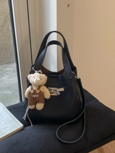 Chic black lychee leather bucket bag with silver H-buckle and cute teddy bear charm