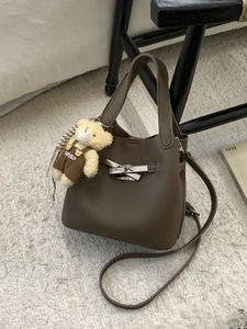 Dark brown pebble leather bucket bag with metal clasp and cute bear pendant charm