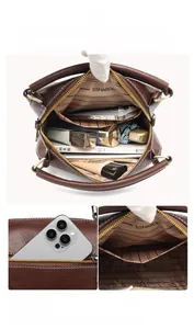 Detail view of large brown faux leather tote showing spacious inner pockets and brand lining