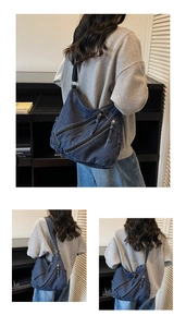 Detail view of deep blue denim tote featuring multi-zipper deconstructed design