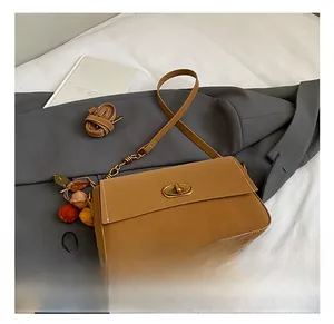 Detailansicht der braunen Vintage-Ledertasche mit Goldschnalle und Kontrastnähten