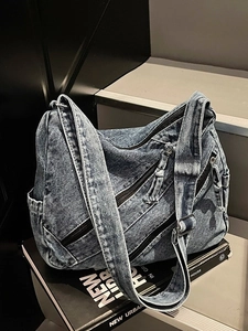 Retro denim tote bag in washed blue with multi-zipper pockets and wide shoulder strap