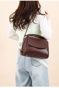 Detail of dark brown vintage faux leather shoulder bag with fine contrast stitching