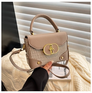 Detail of vintage woven handbag featuring a large golden twist lock and tweed fabric
