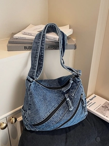 Retro washed blue denim hobo bag with diagonal zippers and wide shoulder strap