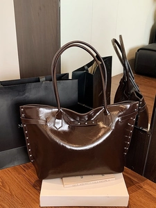 Brown high-gloss large tote bag with silver metal studs for chic commuting and daily use