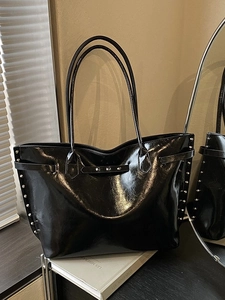 Large black oil wax leather tote bag with silver rivets on a vintage casual shoulder bag