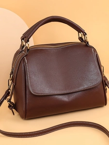 Deep brown soft leather handbag with white contrast stitching and adjustable strap