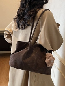 Retro large brown suede tote bag with teddy bear pendant shown on model's shoulder