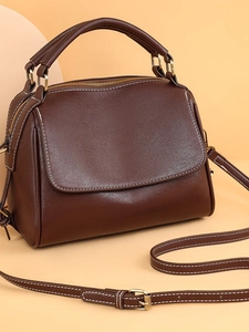 Deep brown vintage leather handbag with white stitching and gold hardware detail