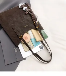 Detailed interior of a vintage brown tote bag showing ample space for tablets and wallets