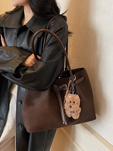Vintage large brown woven leather tote bag for women with a cute dog plush keychain