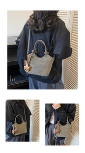 Detail of green bucket bag featuring metal ring hardware and plush bear charm decoration