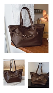 Dettaglio della grande borsa tote marrone scuro con eleganti finiture metalliche dorate