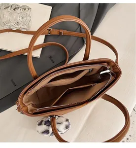 Internal structure of brown retro shoulder bag with multiple compartments and zipper pocket