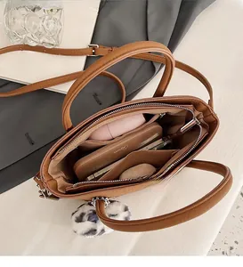 Detail view of the spacious inner compartments of this brown faux leather bucket bag