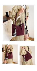 Detail of burgundy vintage tote bag with adjustable strap and cute dog charm accessory