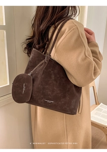 Detail of dark brown suede tote bag featuring a detachable round matching coin purse