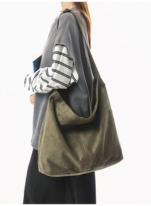 Détail d'un grand sac cabas en toile vert olive montrant la texture souple et le drapé