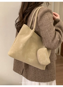 Detail of apricot suede tote bag set with matching coin purse on human model