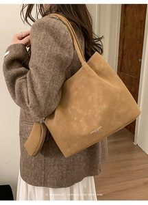 Detail view of large camel tote bag with matching hanging coin purse and fashion text