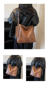 Detail view of large brown vintage tote bag with gold zipper and matching mini pouch