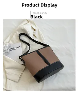 Detailed top view of vintage brown canvas bucket bag with black leather patchwork