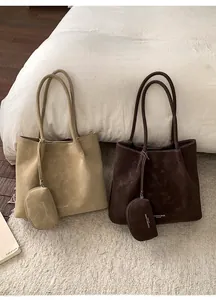 Close-up of vintage frosted leather tote bags in khaki and coffee with matching pouches