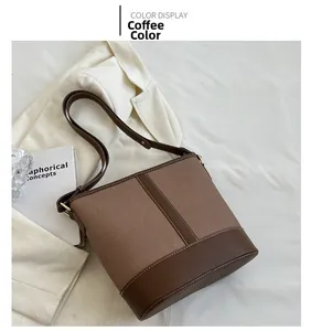 Detail view of vintage patchwork bucket bag in brown canvas and dark coffee leather