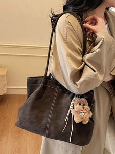 Retro dark brown large tote bag in frosted leather with plush bear pendant and white stitching