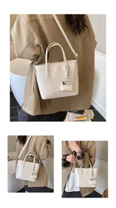 Detail of creamy white PU leather tote bag with a matching mini pouch and logo texture