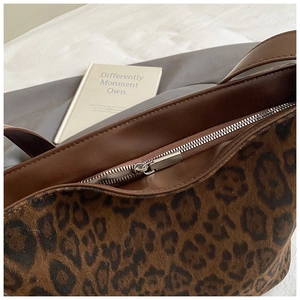 Detail of leopard print tote bag with premium silver zipper and suede texture finish