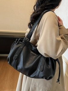 Chic black litchi leather tote bag with drawstring detail and adjustable strap