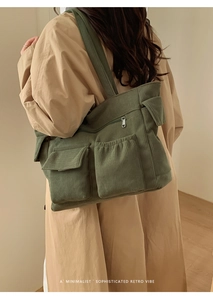 Detail of dark green corduroy shoulder bag featuring retro utility pockets on a coat
