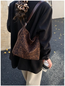Detailed back view of a large leopard print hobo bag with slim leather straps