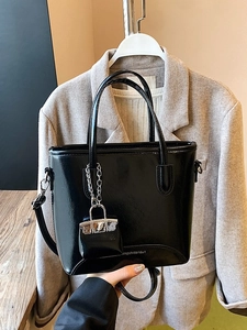 Retro black patent leather bucket bag with mini pendant and adjustable shoulder strap