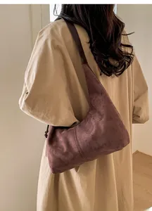 Macro detail of retro suede hobo bag showing deep brown texture and vintage hobo silhouette
