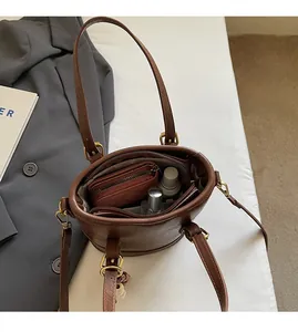 Detailed view of spacious brown bucket bag interior with wallet and cosmetics