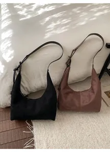 Classic black and coffee matte hobo bags with adjustable straps in a cozy setting