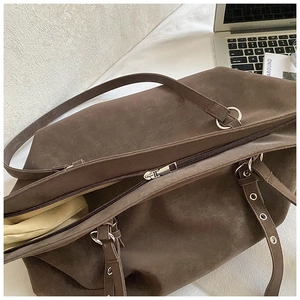 Top view of large dark brown tote bag with silver zipper and vintage leather texture