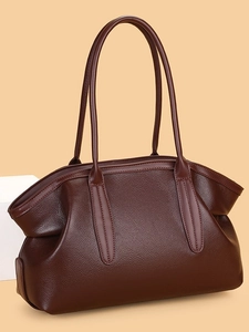 Minimalist dark brown lychee textured leather tote bag shown from a 45-degree angle