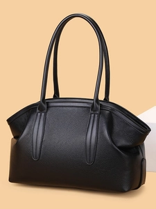Minimalist black lychee leather tote bag with elegant curved top and dual top handles