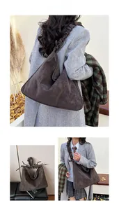 Detailed view of dark brown suede tote bag with stylish ruched shoulder strap design