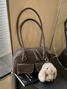 Vintage dark brown Boston bowling bag with front pockets and plush bunny charm