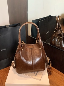 Sac seau rétro en cuir marron avec rivets dorés et bandoulière large tissée vintage
